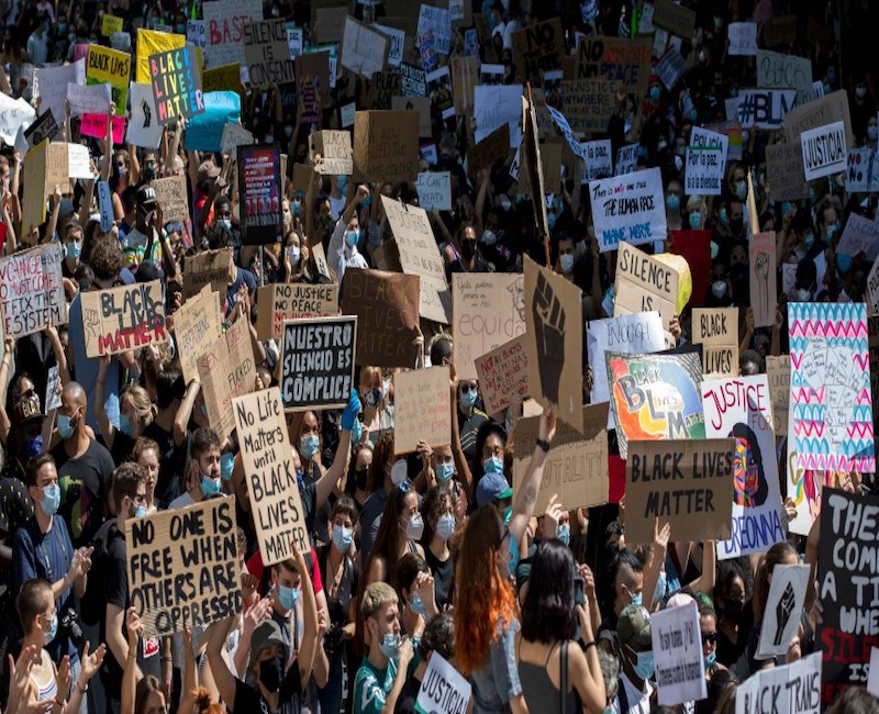 Demonstrators hold placards during Black Lives Matter protest outside the United States Embassy on June 07, 2020 in Madrid, Spain